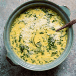 Lentil soup with spinach and coconut milk in blue/ gray bowl