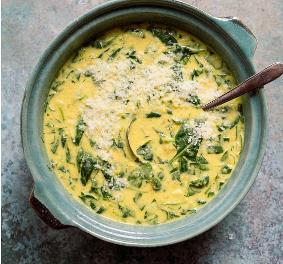 Lentil soup with spinach and coconut milk in blue/ gray bowl