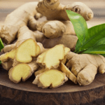 Ginger Root: whole and sliced on a wooden board