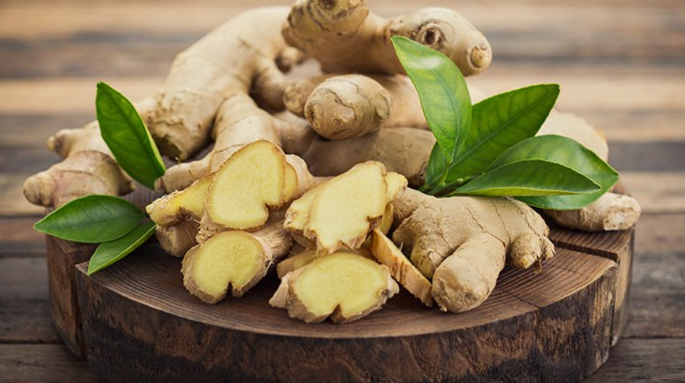 Ginger Root: whole and sliced on a wooden board